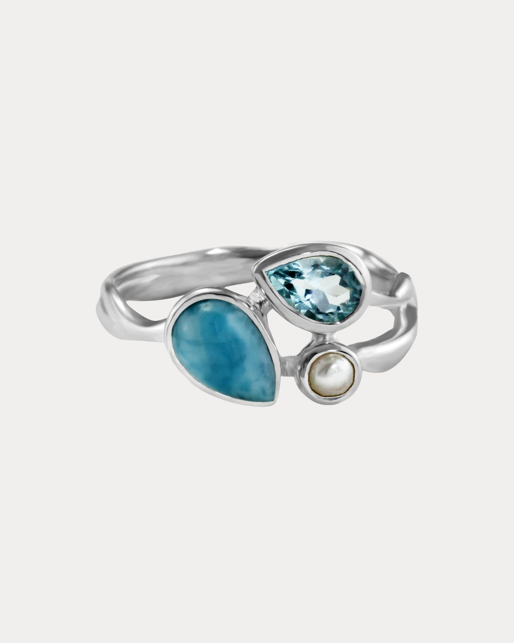 Silver ring with blue gemstones on a white background