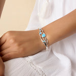 Model wearing silver and blue opal bracelet on their wrist