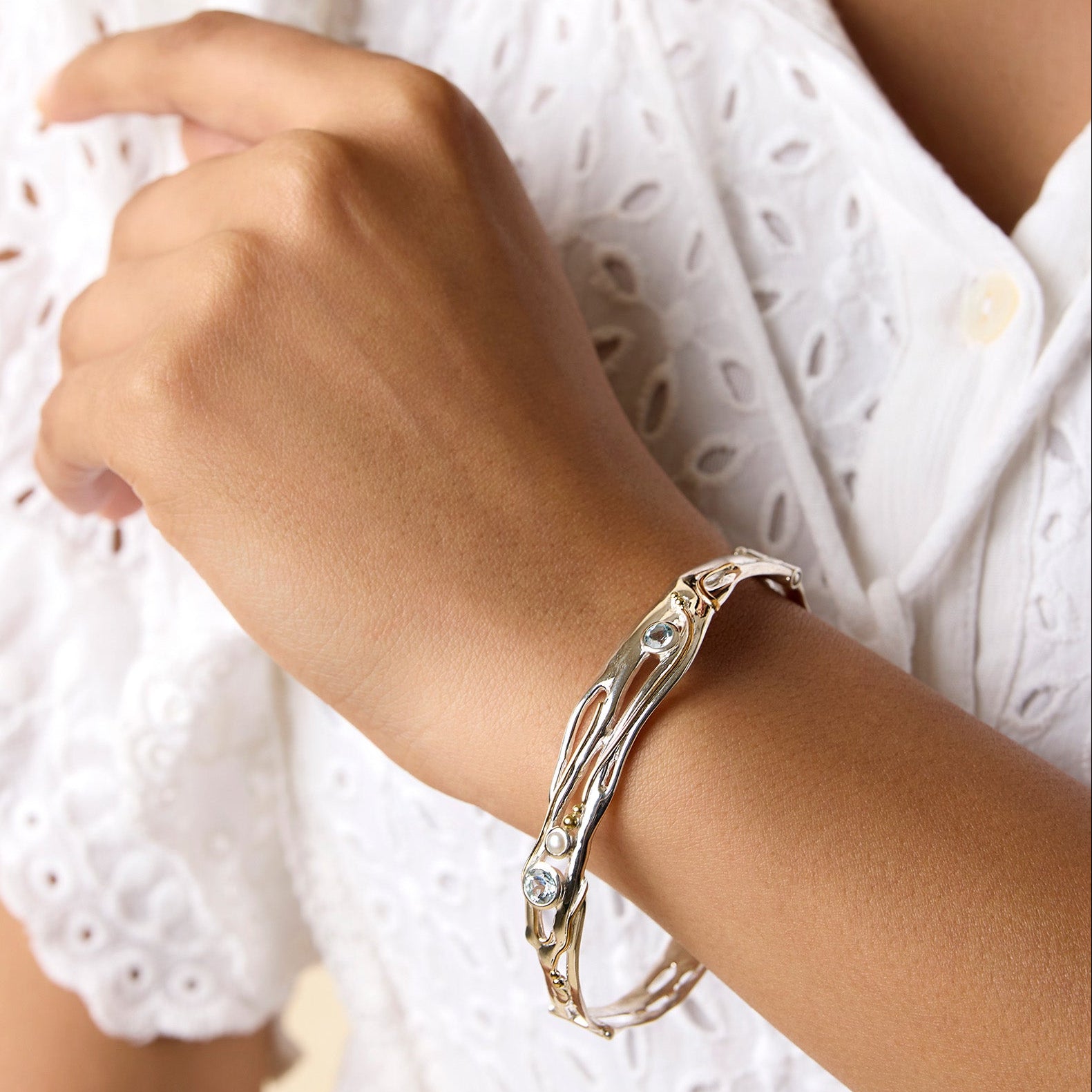 Organic Blue Topaz and Pearl Bracelet on a model's wrist