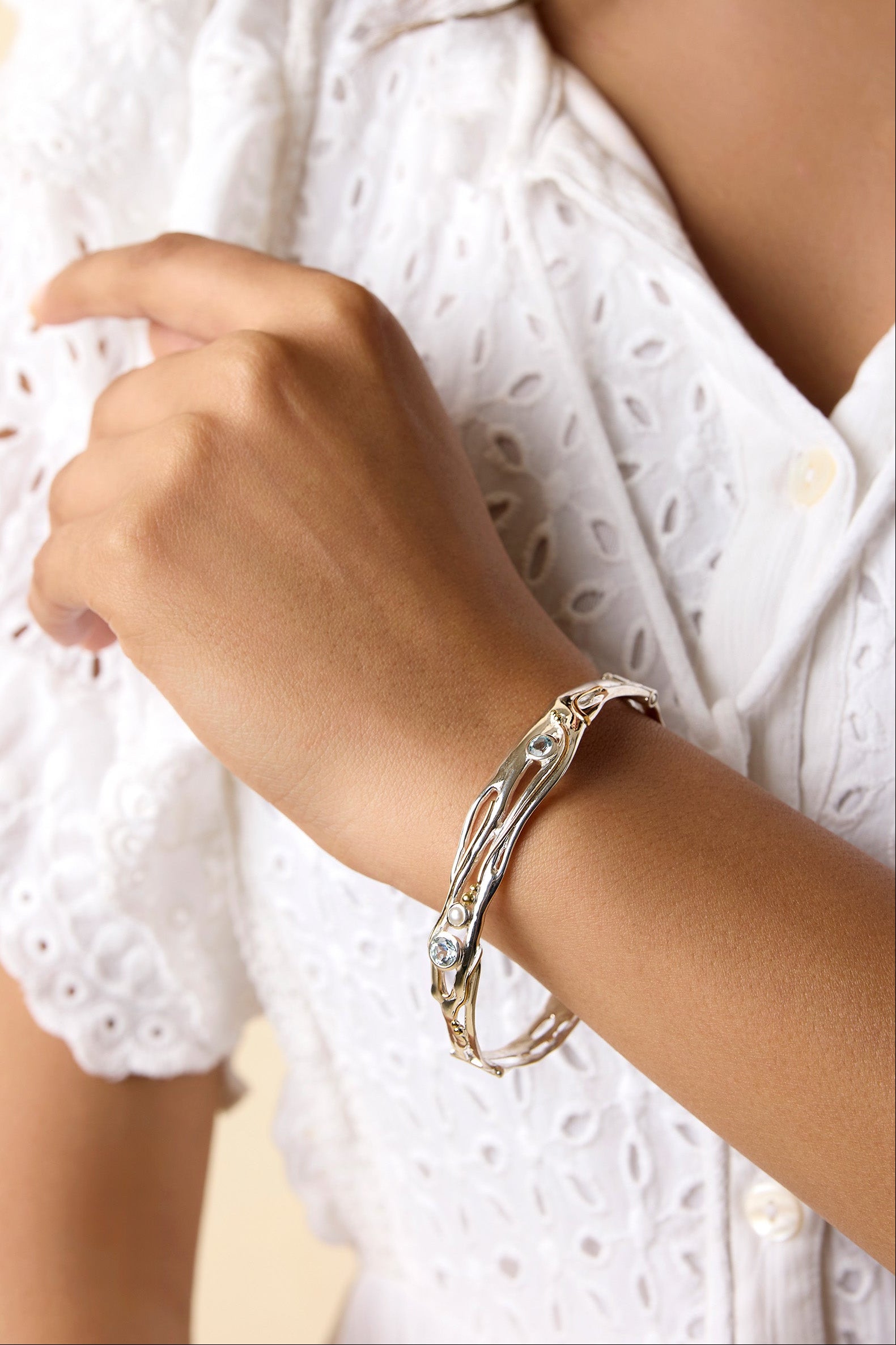 Organic Blue Topaz and Pearl Bracelet on a model's wrist