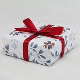 A jewellery box is beautiful wrapped with Isla Silver's signature Christmas wrapping paper and finished with a red ribbon.