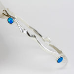 Silver bracelet with blue Opal stones on a white background