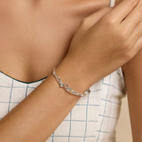 Model wearing a silver bracelet with Blue Topaz and Pearl stones