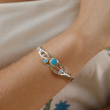Silver bracelet with blue stones on a wrist with summer clothes