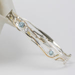 sterling silver bangle with blue topaz, pearl and gold details