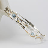 sterling silver bangle with blue topaz, pearl and gold details