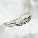 Silver bracelet on a white stone surface