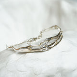 Silver bracelet on a white stone surface