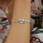 mixed metal bracelet worn on model's wrist