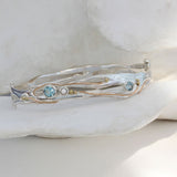 Sterling silver handcrafted bangle with blue topaz and pearl stones