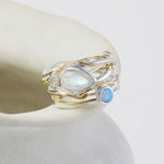 Gold and silver ring with gemstones on a white background