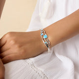 Model wearing silver and blue opal bracelet on their wrist