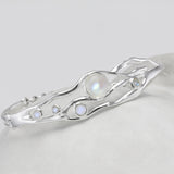 Silver bracelet with moonstones on a white background