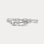 A Sterling Silver bangle bracelet with organic shape and five Moonstone gemstones set within the flowing Silver.