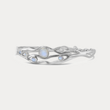 A Sterling Silver bangle bracelet with organic shape and five Moonstone gemstones set within the flowing Silver.