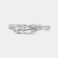 A Sterling Silver bangle bracelet with organic shape and five Moonstone gemstones set within the flowing Silver.
