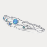 Silver bracelet with opal stones on a white background