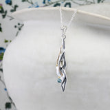 Handmade Flowing Silver Pendant with Blue Topaz and 14kt Gold Details